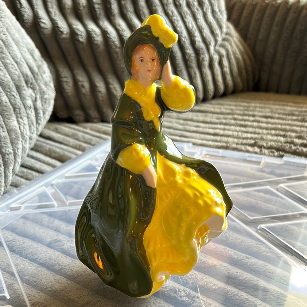 Elegant Porcelain or Ceramic Figurine of a Woman in a Green and Yellow Dress